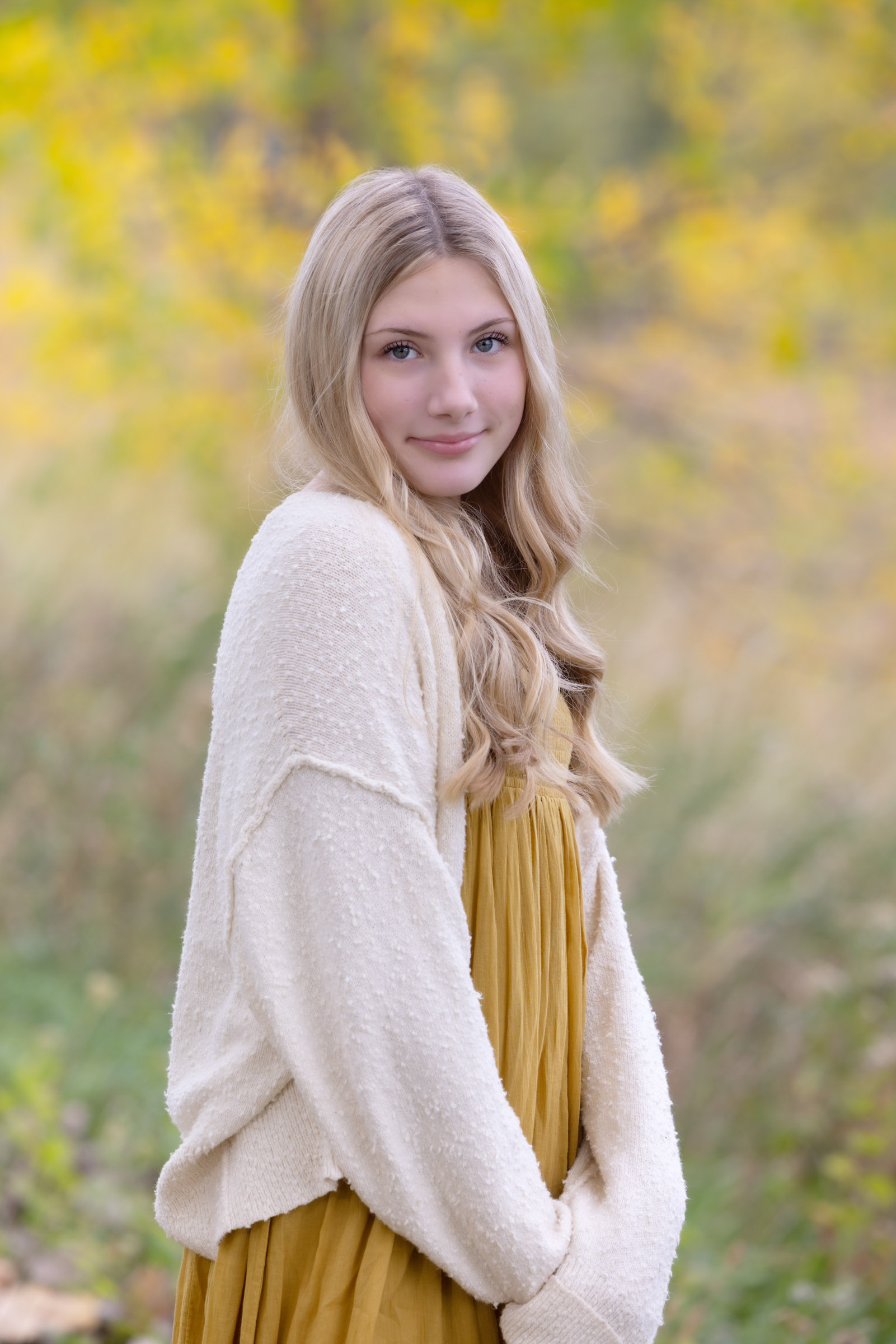 Teenager standing outdoors during a portrait session.