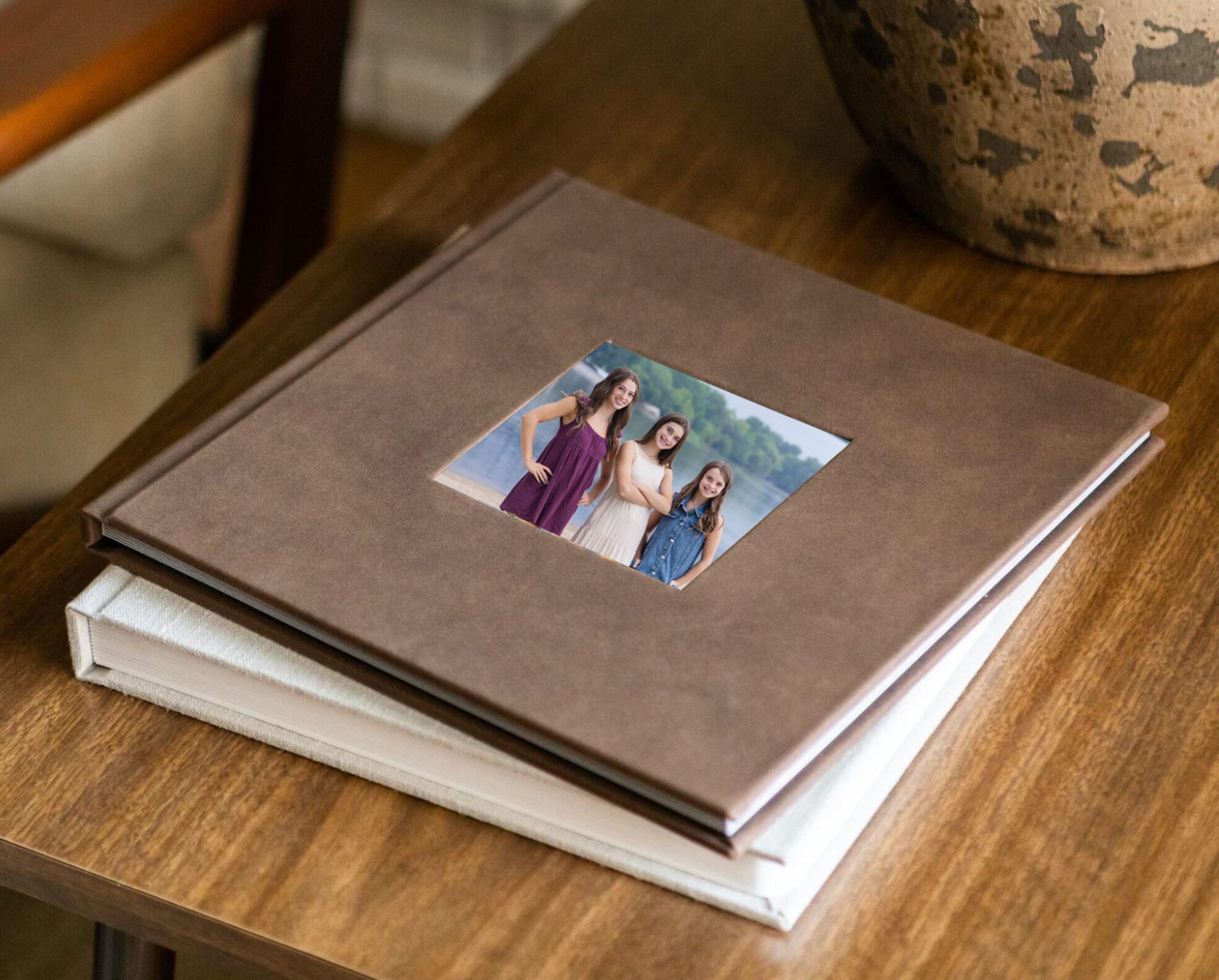Custom family portrait album displayed on a wooden table.
