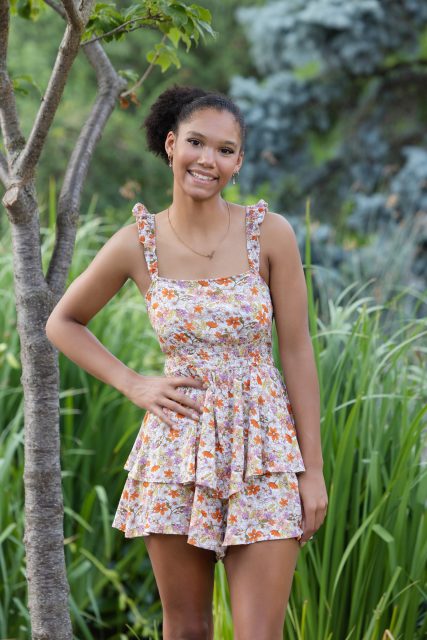 High school senior standing outdoors during a portrait session.