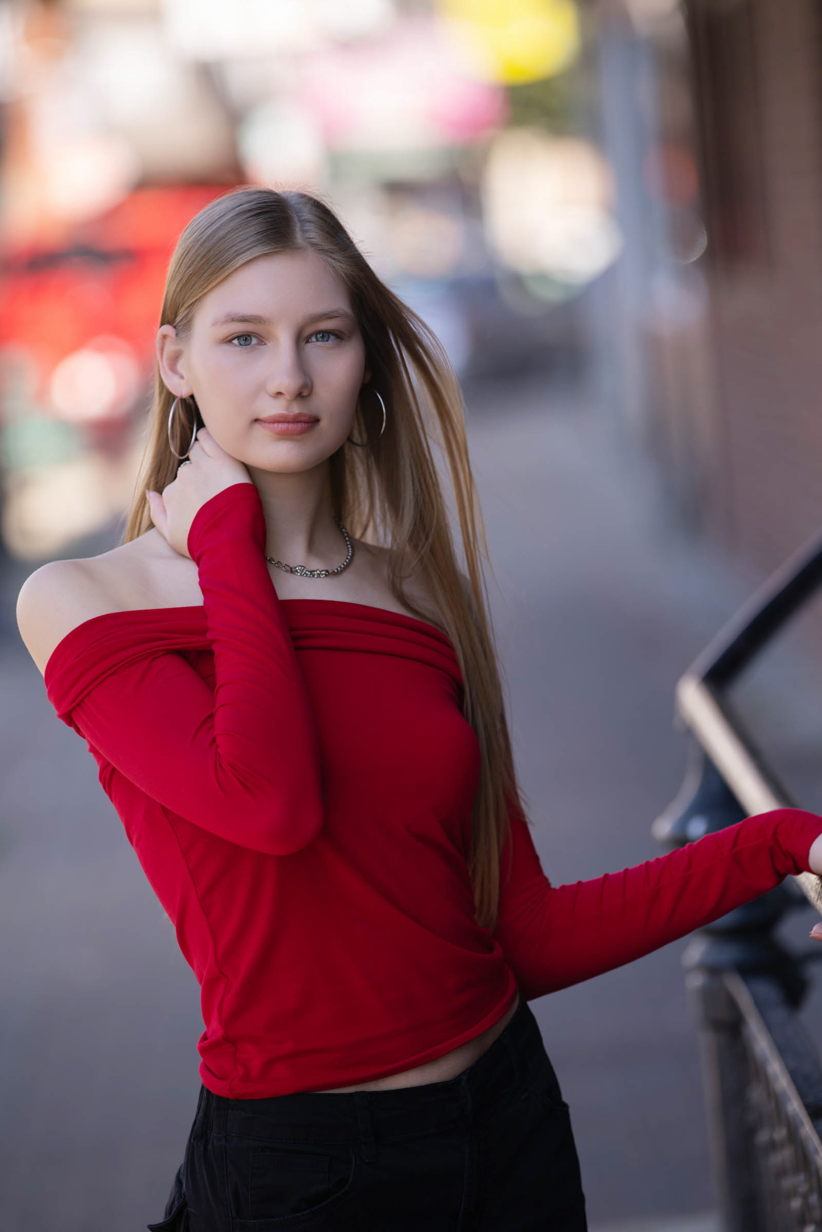High school senior standing in a downtown setting during a senior portrait session.