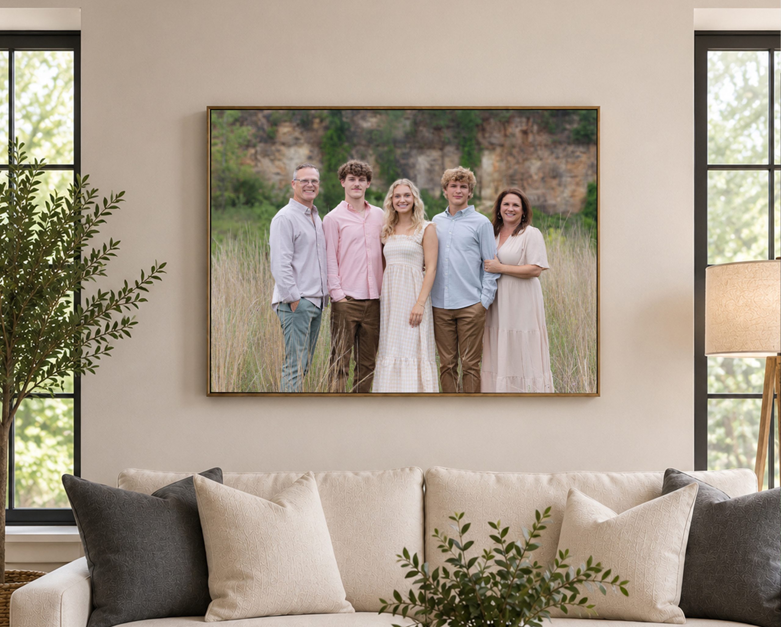 Large framed family portrait displayed above a sofa in a living room.