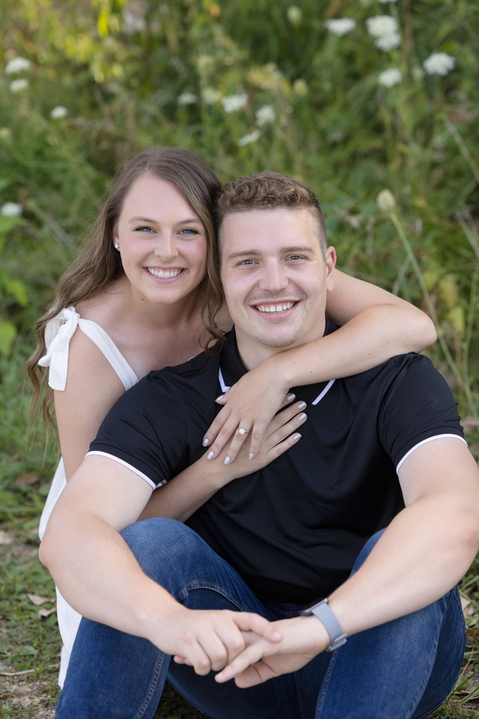 Engaged couple smiling during an outdoor portrait session