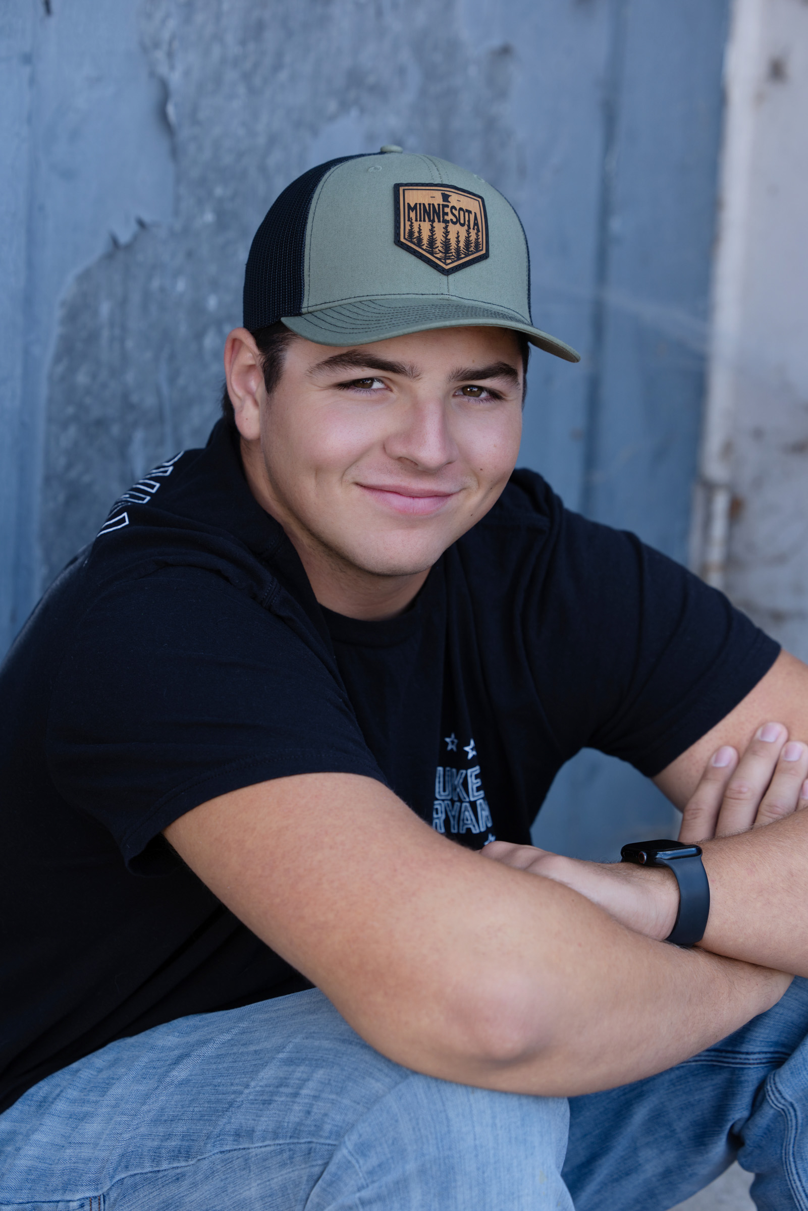 Close-up portrait of a high school senior smiling toward the camera.